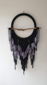 Black dreamcatcher with driftwood and feathers
