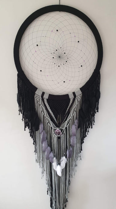 Handmade black and grey dreamcatcher with crystal and feather detail.