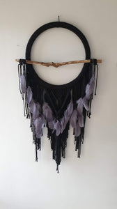 Black dreamcatcher with driftwood and feathers